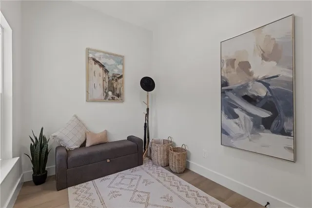 a living room with furniture and a painting on the wall