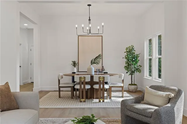 a living room with furniture a chandelier and a window
