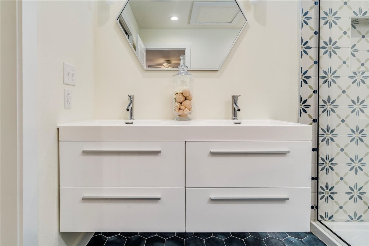 1120 Spur Street Austin, TX 78721 - Photo 14 of 31 a bathroom with a sink and a mirror