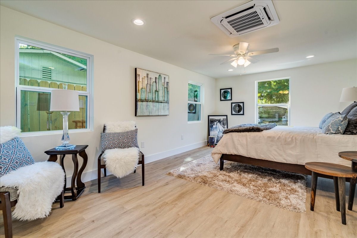 1120 Spur Street Austin, TX 78721 - Photo 15 of 31 a bed room with a bed window and a chair