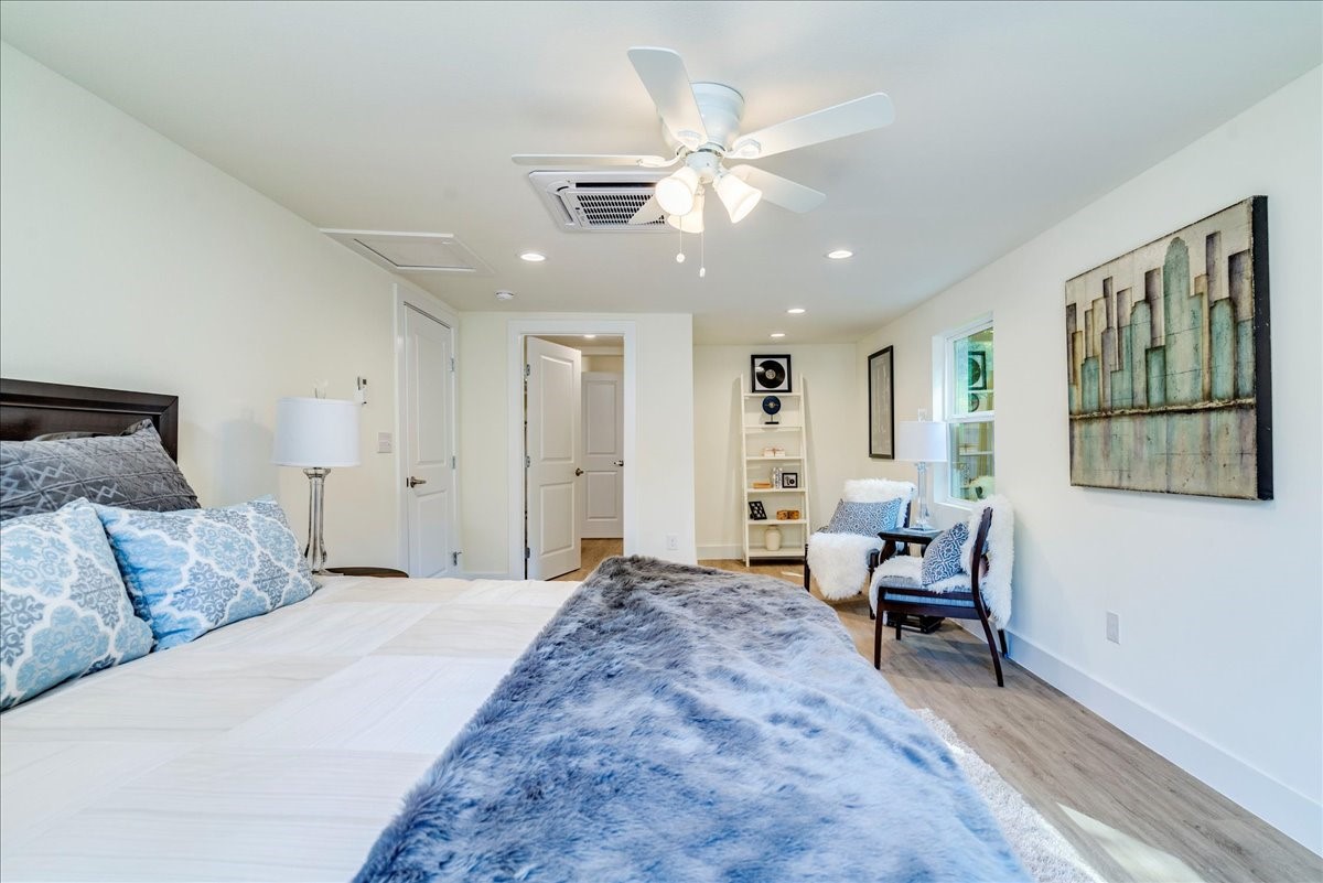 1120 Spur Street Austin, TX 78721 - Photo 16 of 31 a bedroom with a bed and a chandelier