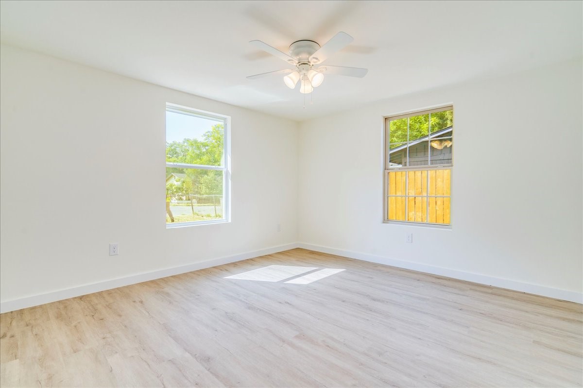 1120 Spur Street Austin, TX 78721 - Photo 17 of 31 wooden floor in an empty room with a window