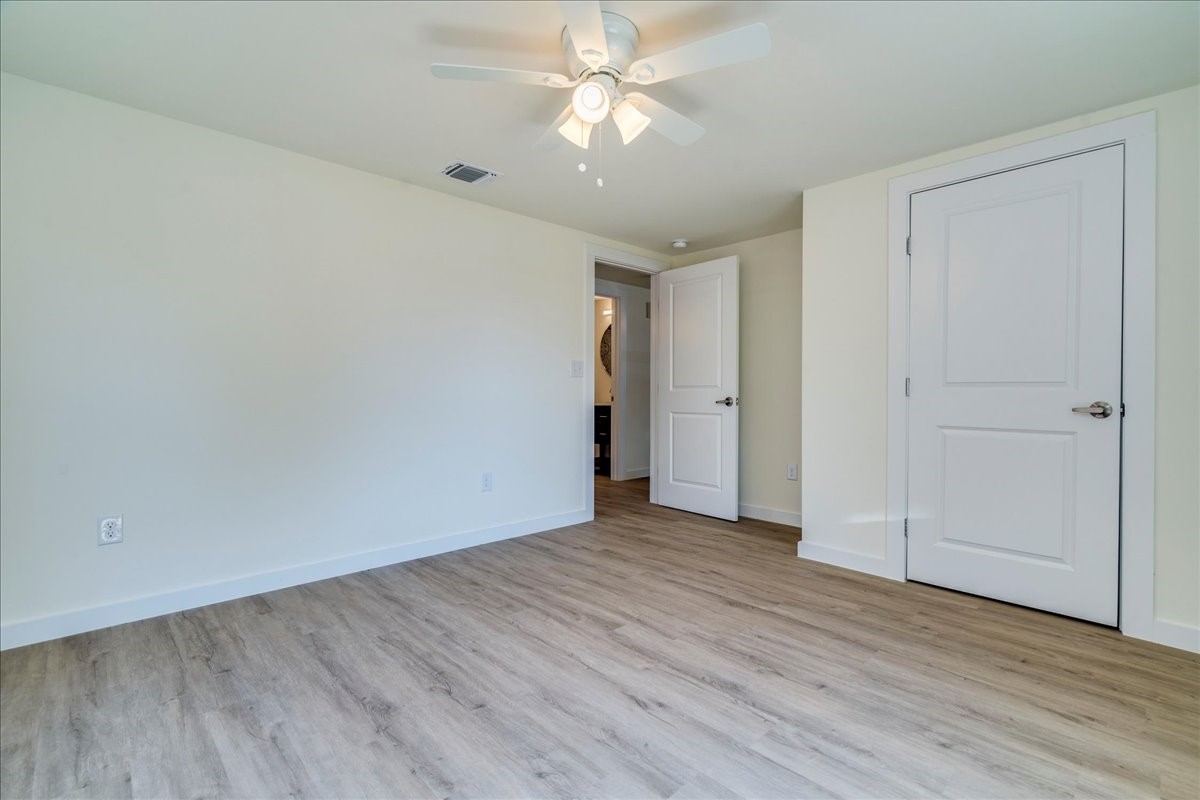 1120 Spur Street Austin, TX 78721 - Photo 18 of 31 a view of an empty room with wooden floor