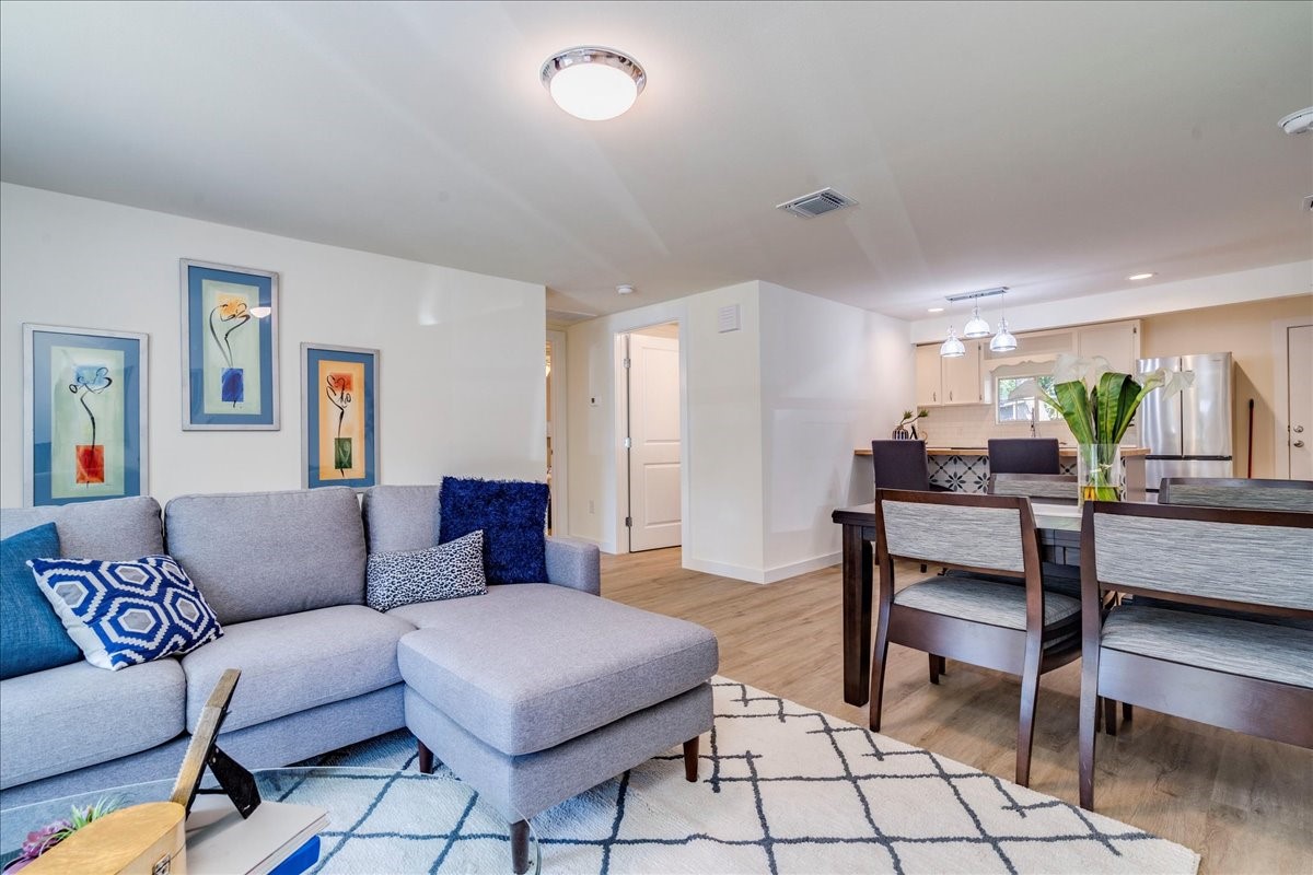1120 Spur Street Austin, TX 78721 - Photo 2 of 31 a living room with furniture and a dining table with kitchen view