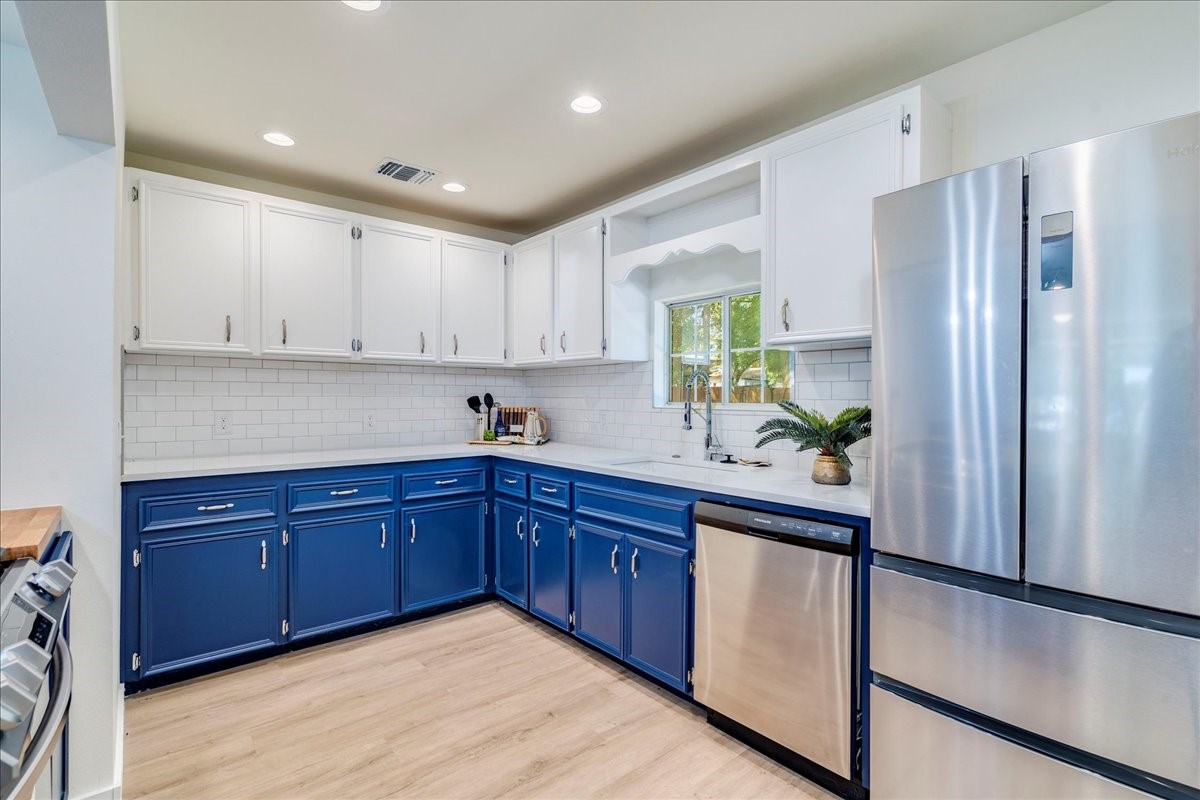 1120 Spur Street Austin, TX 78721 - Photo 6 of 31 a kitchen with stainless steel appliances granite countertop a refrigerator and a sink