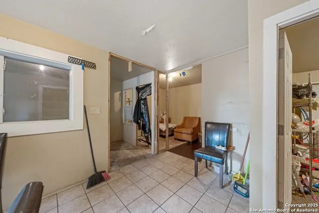 a living room with furniture a mirror and a couch
