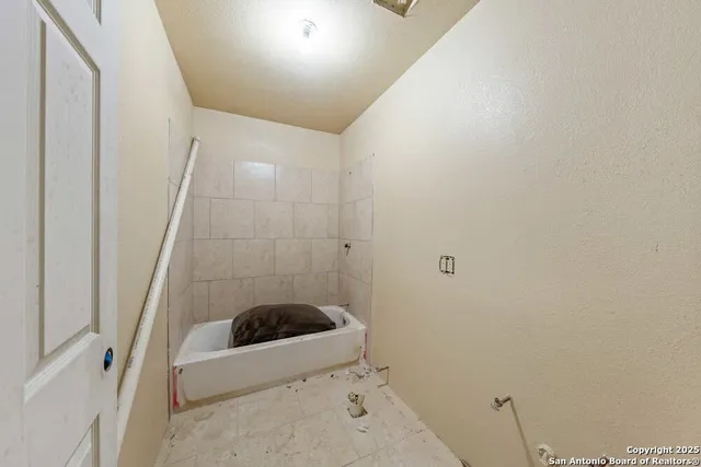 a bathroom with a bathtub and shower