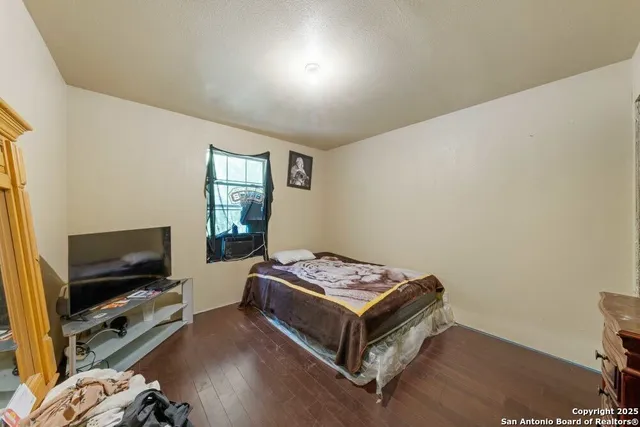a bedroom with a bed and flat screen tv