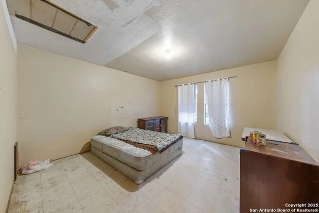 a spacious bedroom with a bed and window