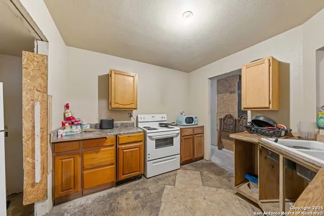 a kitchen with a stove top oven sink and cabinets
