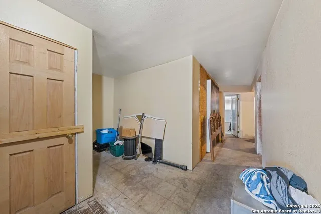 a view of a livingroom with furniture and an empty room