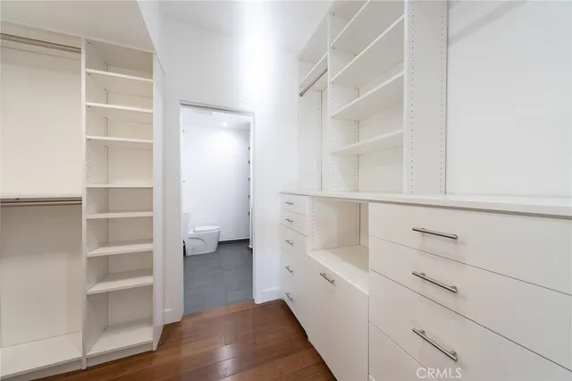 a view of walk in closet with empty racks