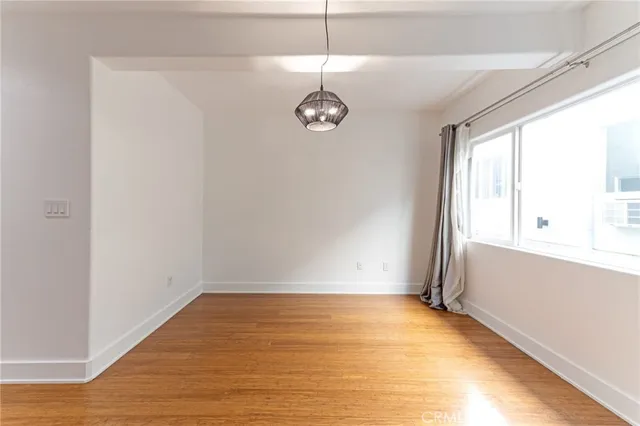 a view of a room with wooden floor and window