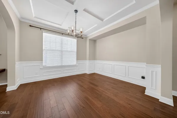 a living room with furniture kitchen view and a chandelier