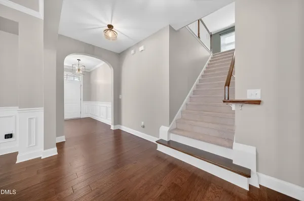 a kitchen with kitchen island granite countertop a white cabinets and refrigerator