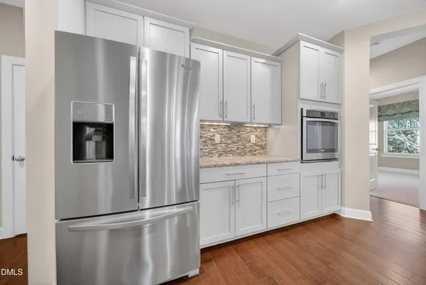 a kitchen with stainless steel appliances granite countertop a refrigerator sink and microwave