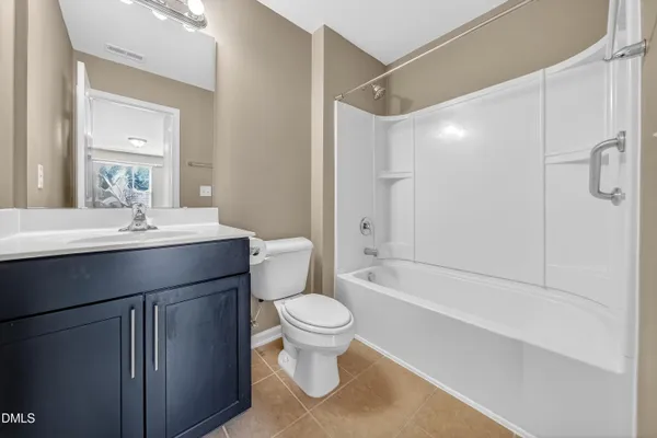 a view of empty room with wooden floor and ceiling fan