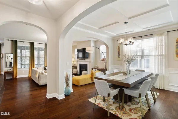 a view of a dining room with furniture wooden floor and chandelier