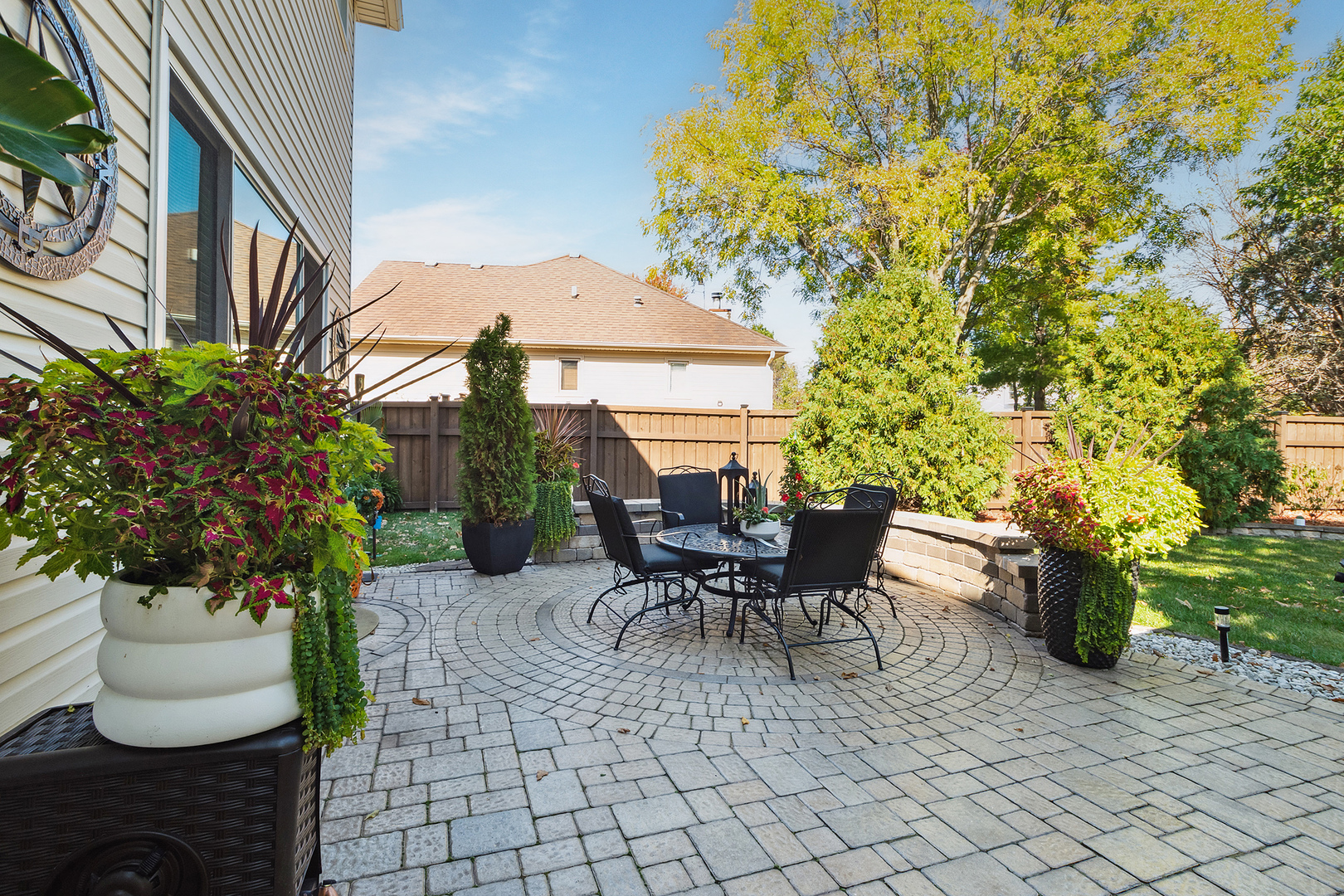 806 Wescott Road Bolingbrook, IL 60440 - Photo 27 of 28 a view of a patio with table and chairs potted plants and wooden fence