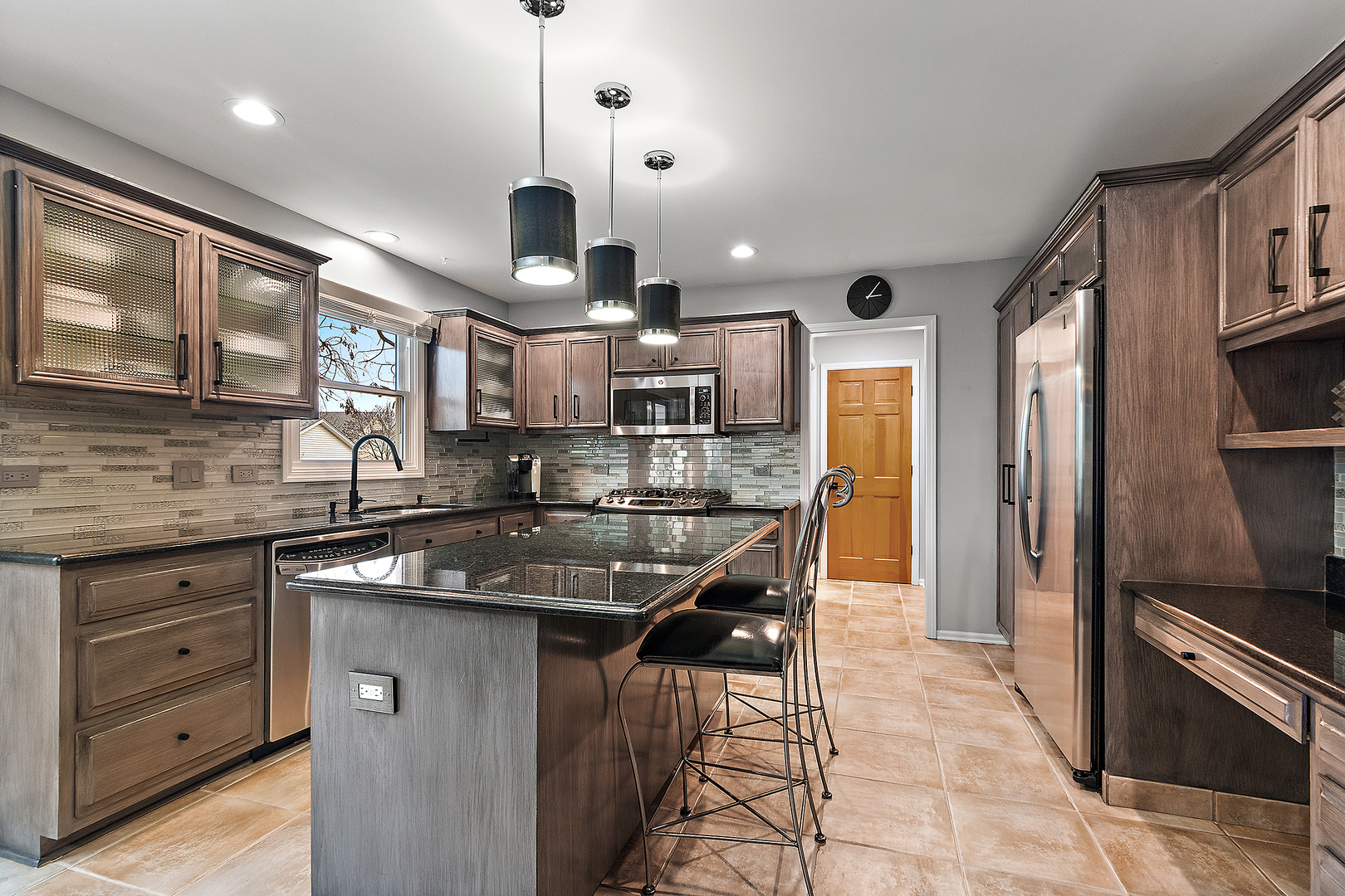 806 Wescott Road Bolingbrook, IL 60440 - Photo 3 of 28 a kitchen with stainless steel appliances granite countertop a sink a stove and a refrigerator