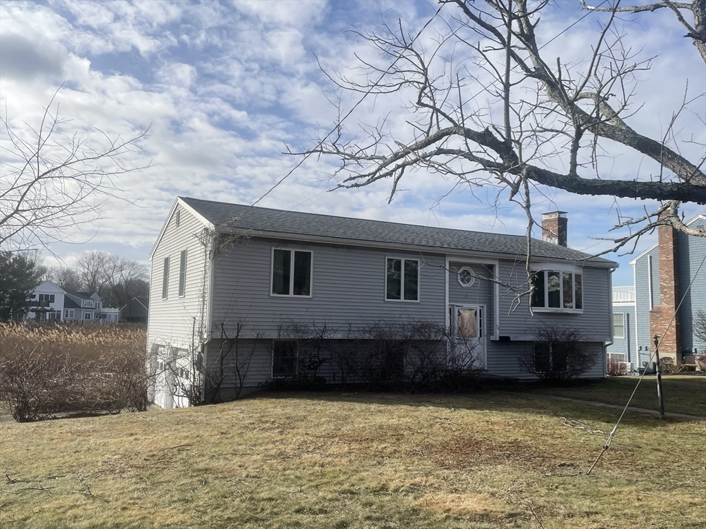 53 Bel Air Road Hingham, MA 02043 - Photo 3 of 10 a front view of a house with a yard and garage