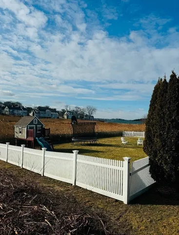 a view of a swimming pool with a table and chairs under an umbrella