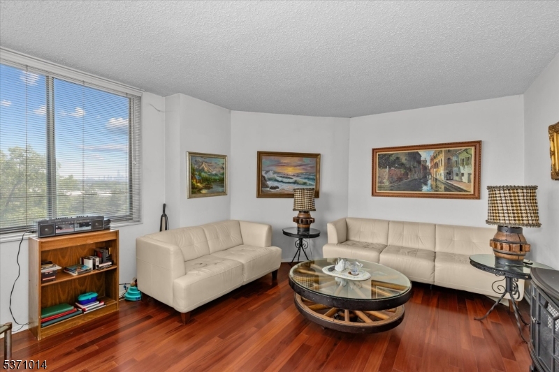 401 Harmon Cove Tower Secaucus, NJ 07094 - Photo 11 of 47 a living room with furniture and a wooden floor