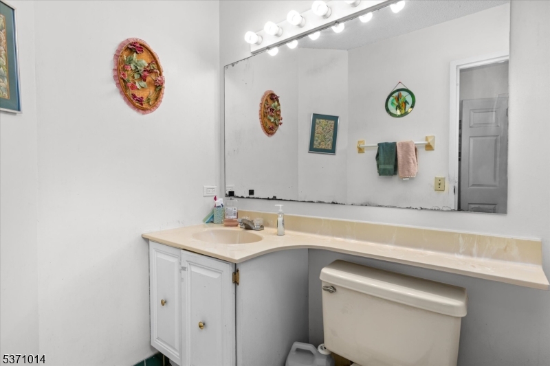401 Harmon Cove Tower Secaucus, NJ 07094 - Photo 18 of 47 a bathroom with a sink a vanity and a mirror