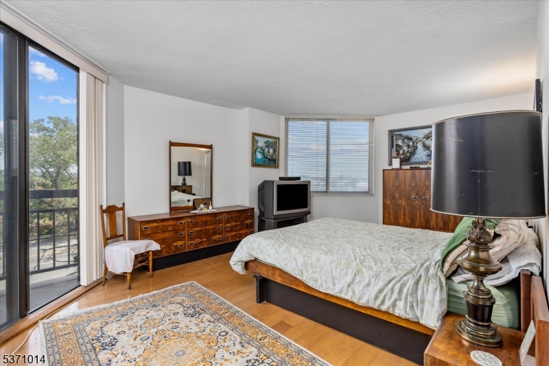 401 Harmon Cove Tower Secaucus, NJ 07094 - Photo 20 of 47 a bedroom with a bed and a couch