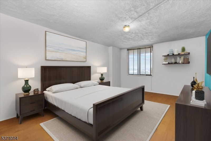 401 Harmon Cove Tower Secaucus, NJ 07094 - Photo 25 of 47 a bedroom with a bed and window