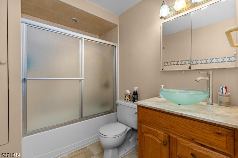 401 Harmon Cove Tower Secaucus, NJ 07094 - Photo 28 of 47 a bathroom with a granite countertop sink mirror vanity and toilet