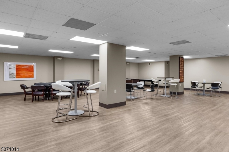 401 Harmon Cove Tower Secaucus, NJ 07094 - Photo 36 of 47 a view of a dining room with furniture and wooden floor