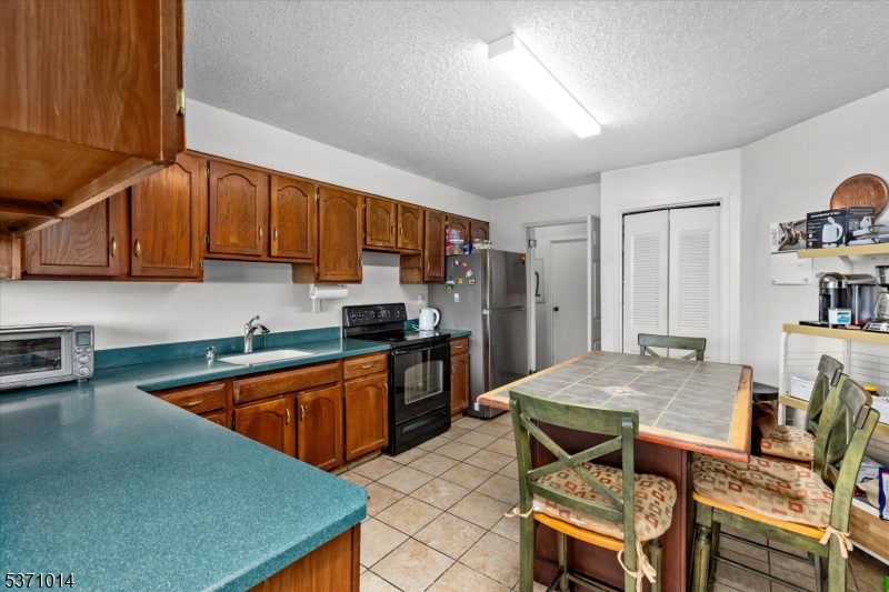 401 Harmon Cove Tower Secaucus, NJ 07094 - Photo 9 of 47 a kitchen with granite countertop a stove a sink dishwasher and cabinets with wooden floor