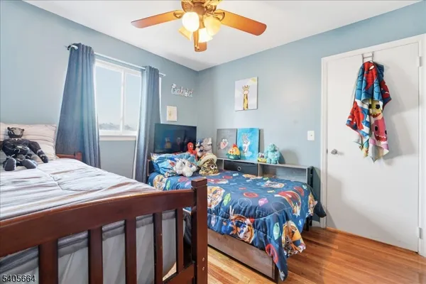 a bedroom with furniture and a baby crib