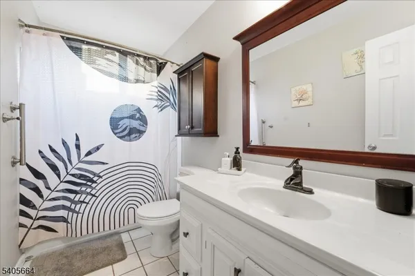 a bathroom with a sink a mirror a toilet and a mirror