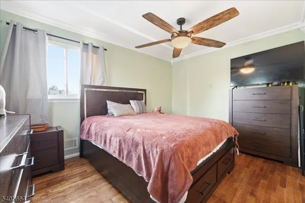 a bedroom with a bed and a ceiling fan