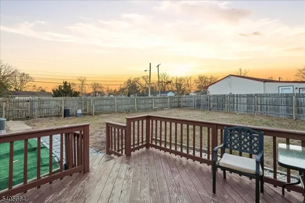 a view of a roof deck with wooden fence