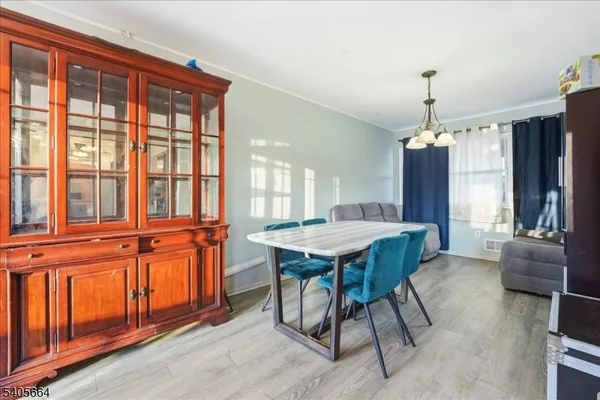 a dining room with furniture window and wooden floor