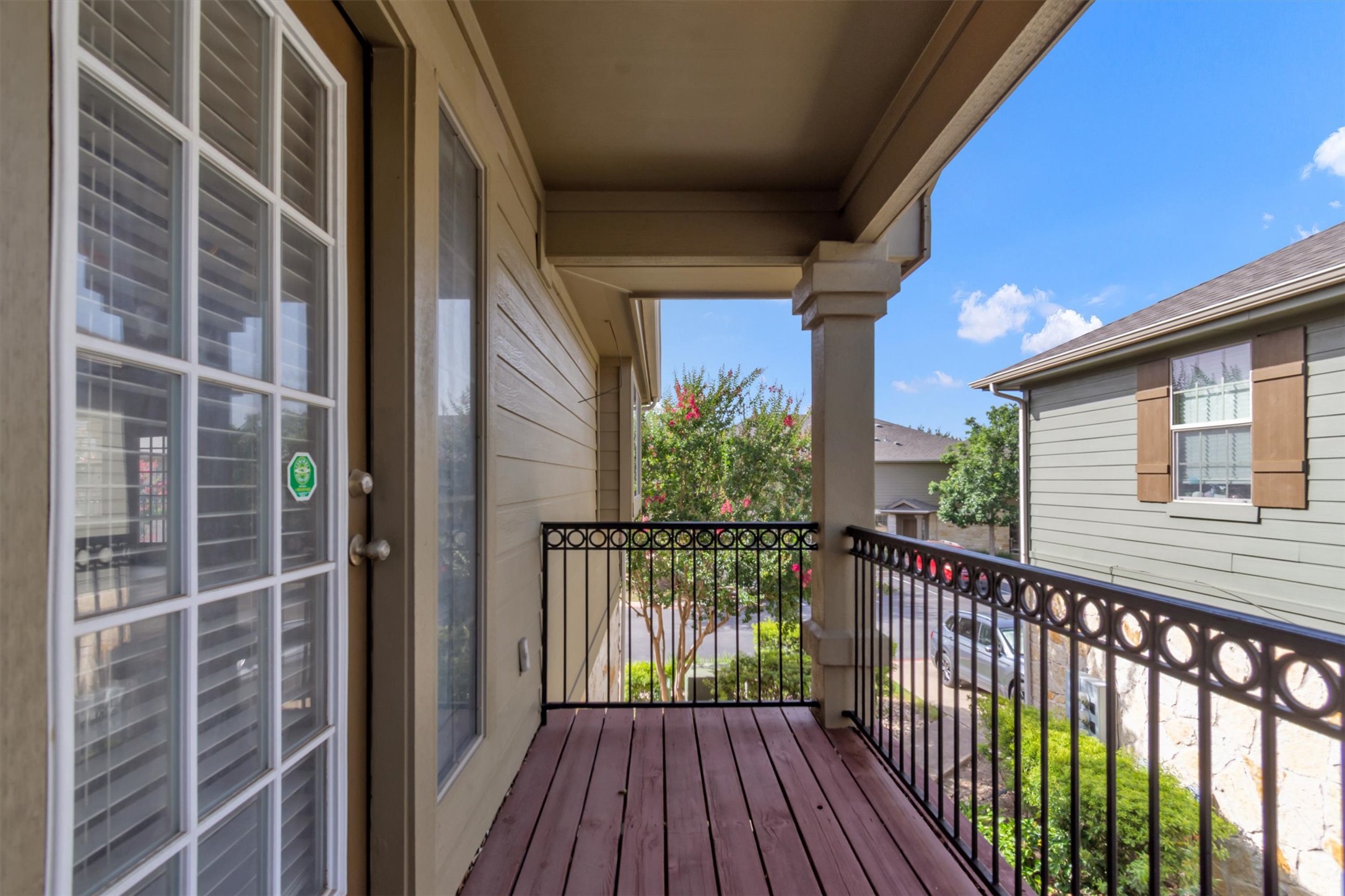 14815 Avery Ranch Boulevard, Unit 2A Austin, TX 78717 - Photo 22 of 27 Step out onto this inviting outdoor balcony, featuring decorative iron railings and a durable wood floor.