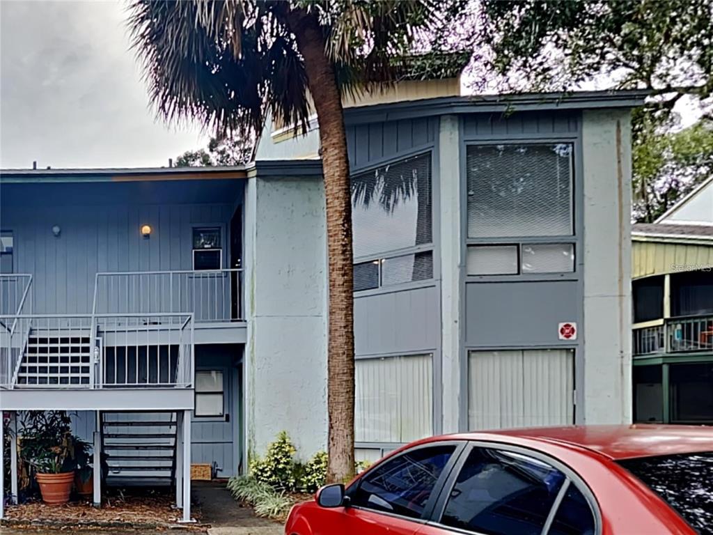 2546 Lemon Tree Lane, Unit G Orlando, FL 32839 - Photo 1 of 28 a front view of a house with parking