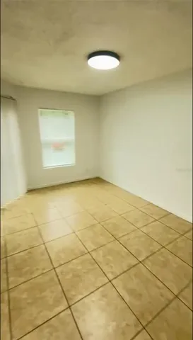 a view of a room with a white wall and a window