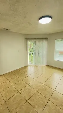 a spacious bedroom with a bed and a shower