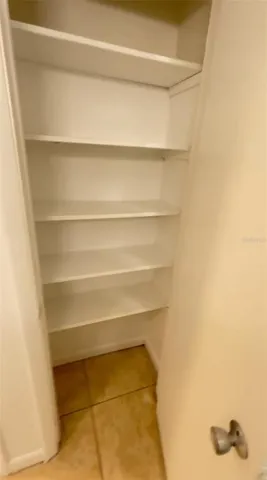 a view of closet with wooden floor