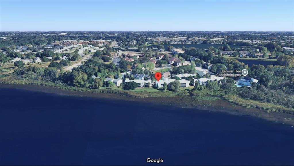 2546 Lemon Tree Lane, Unit G Orlando, FL 32839 - Photo 20 of 28 an aerial view of a houses with a yard and lake view