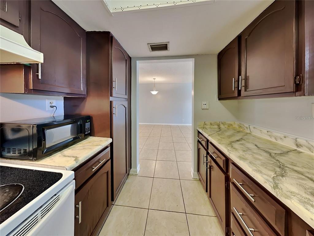 2546 Lemon Tree Lane, Unit G Orlando, FL 32839 - Photo 22 of 28 a kitchen with a stove and a sink