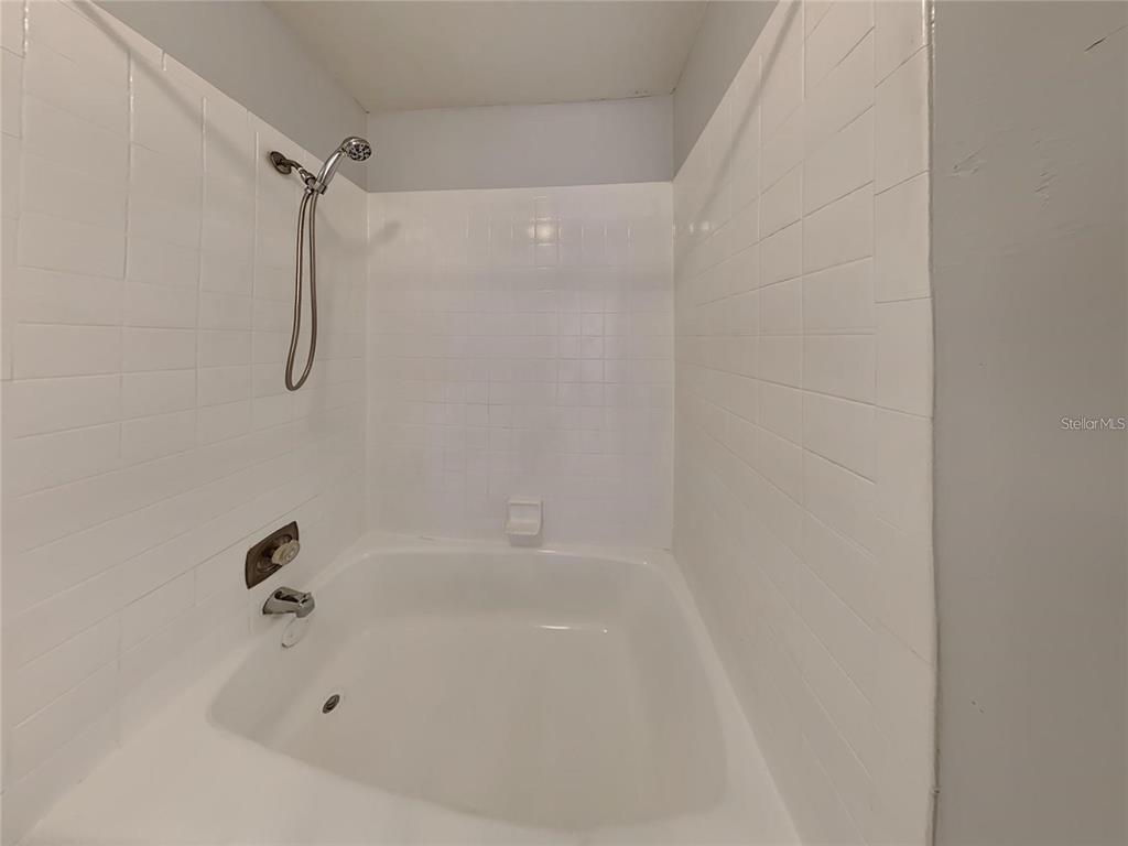 2546 Lemon Tree Lane, Unit G Orlando, FL 32839 - Photo 27 of 28 a bathroom with a bath tub with a shower
