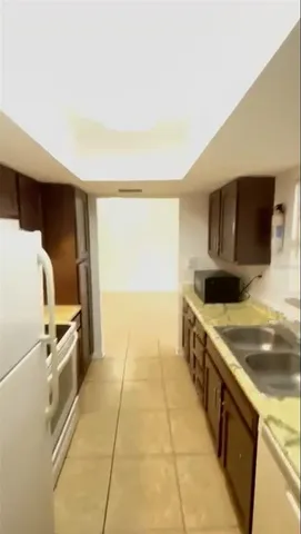 a kitchen with stainless steel appliances a stove a microwave and a refrigerator