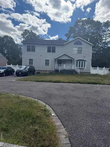 a view of a big house with a big yard and large trees