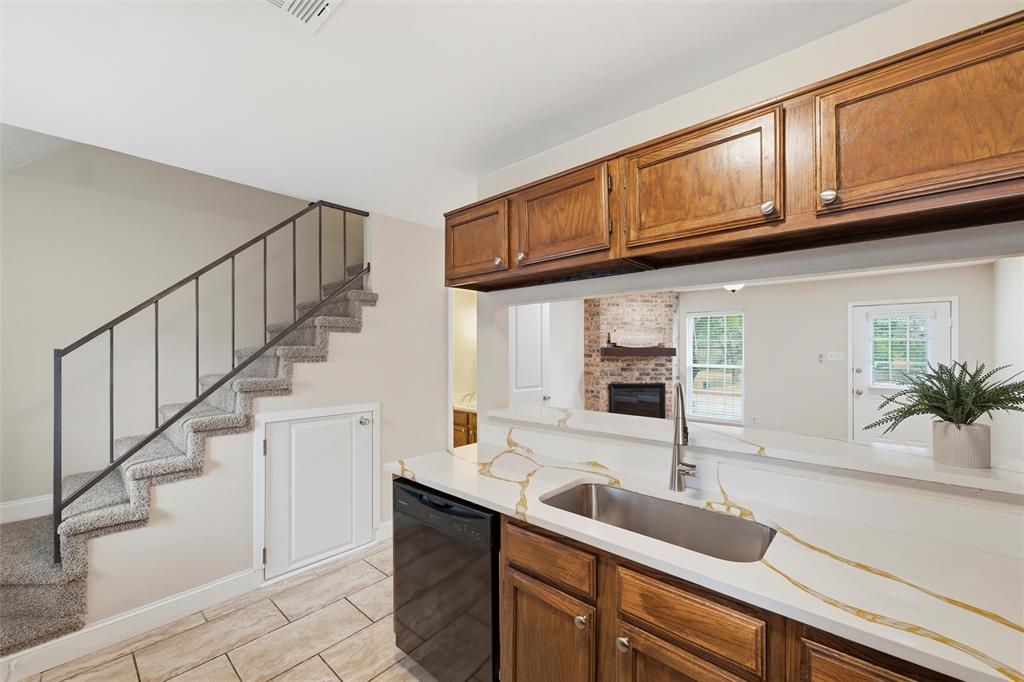 112 Churchill Lane Euless, TX 76039 - Photo 11 of 33 a kitchen with granite countertop a sink a stove and cabinets