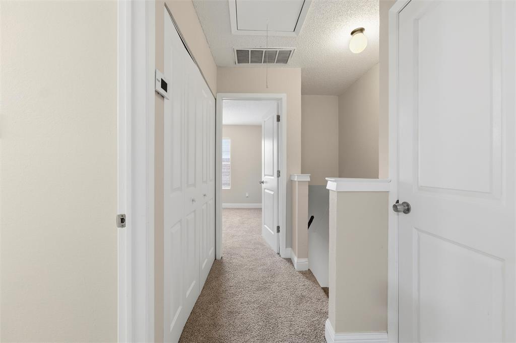 112 Churchill Lane Euless, TX 76039 - Photo 14 of 33 a view of a hallway with a white walls